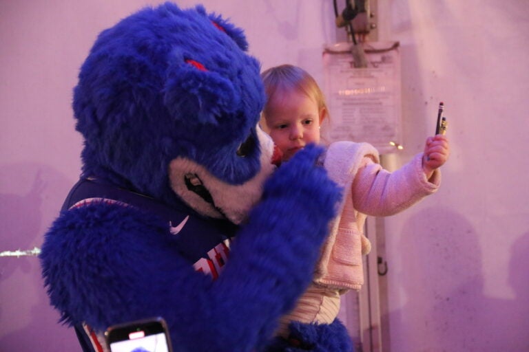 The Philadelphia 76ers and Toyota served a Thanksgiving dinner to military service members and veterans onboard the Battleship New Jersey on Monday night in Camden, New Jersey. (Cory Sharber/WHYY)
