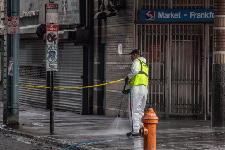 Workers cleaning the sidewalk