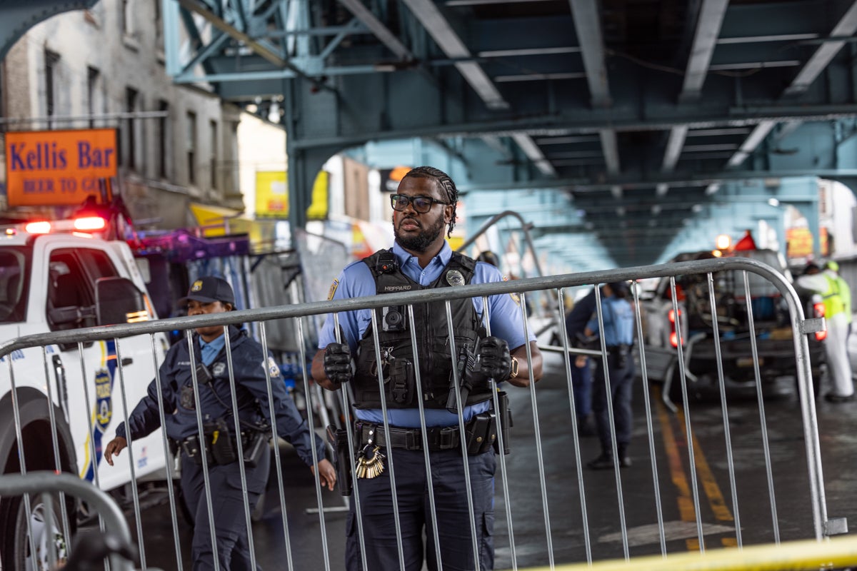 A police officer sets up a barricade on the street