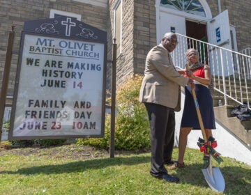 two people with a shovel at the groundbreaking
