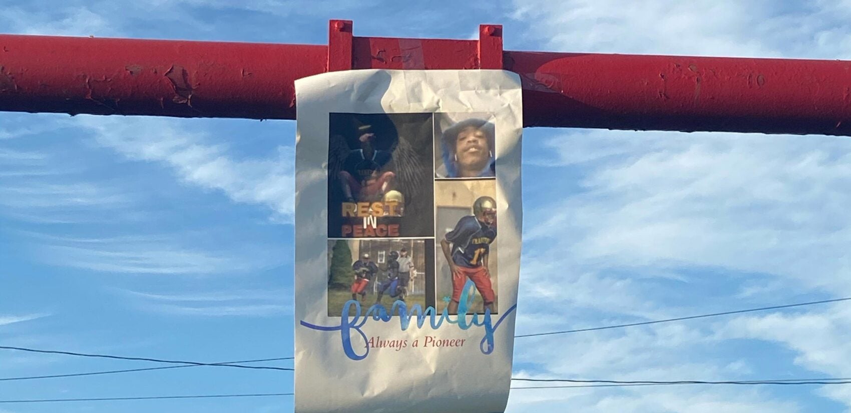 A flyer hangs on the goal post of the Frankford High School football field during Angelo Walker's memorial. (Courtesy of Isabella DiBileo)