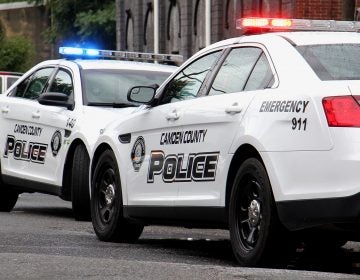 Camden police cars on the street with lights flashing