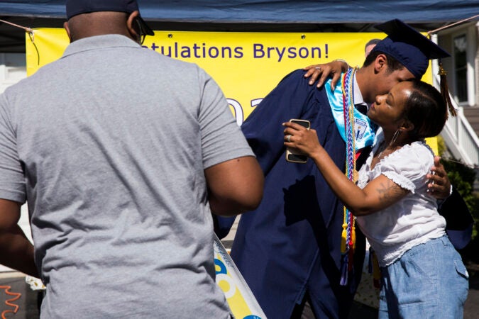 Bryson receives congratulations from his parents, Elaina and Greg, after receiving his high school diploma via a modified graduation ceremony on June 9, 2020. (Rachel Wisniewski for Keystone Crossroads)