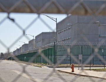 The exterior of Curran-Fromhold Correctional Facility as seen through a fence