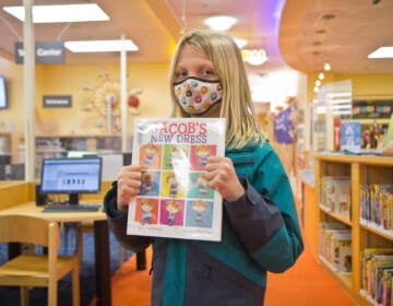Connor holds a favorite book at the Abington Township Public Library. (Kimberly Paynter/WHYY)