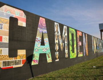 Five local artists contributed to the making of the 'Camden Invincible'' mural at 16th Street and Admiral Wilson Boulevard. (Emma Lee/WHYY)
