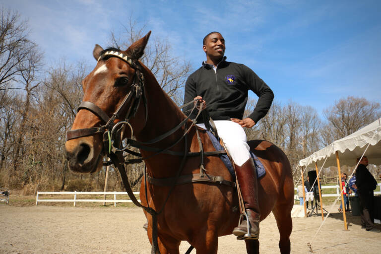 Kareem Rosser sits on top of a horse in Fairmount Park