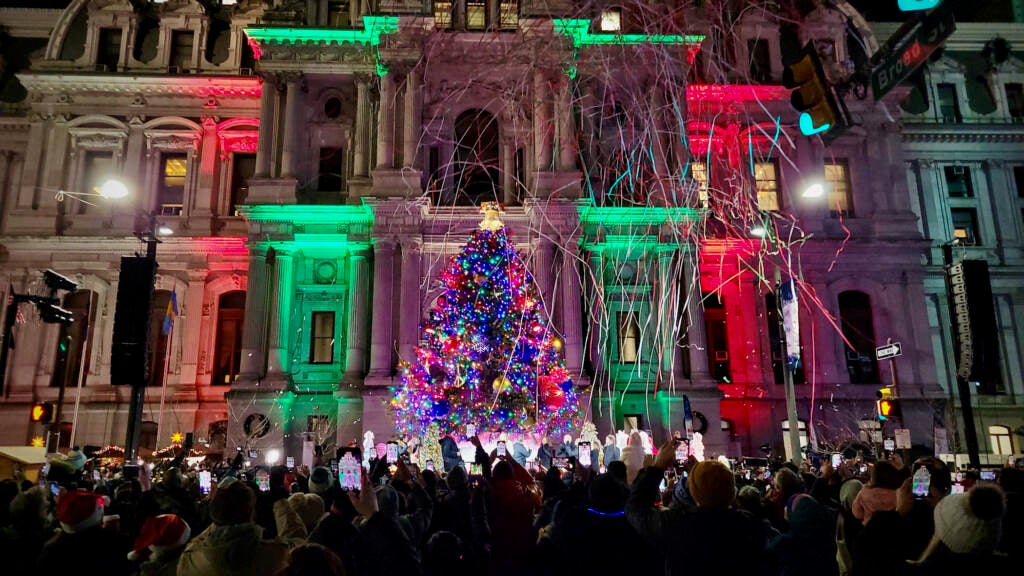 A Christmas tree is lit outside Philadelphia City Hall
