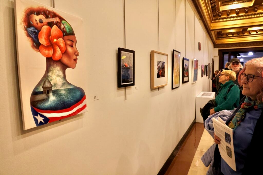 Visitors look at art