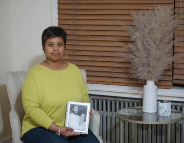 Tamika Morales holds a photo of herself and her son, Ahmad Morales.