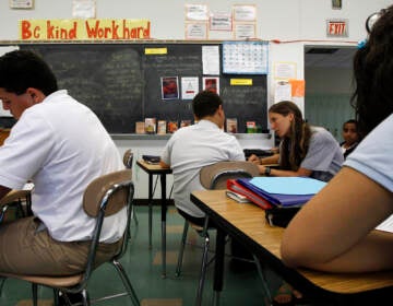 Teacher Laura Kangay, (center) helps a student with his reading at Lincoln Middle School Friday, Sept. 30, 2011 in Lancaster, Pa. Financial woes have forced school districts to shed thousands of teaching jobs, adopt a four-day school week and cut electives such as art. And the budget situation probably wont improve any time soon for school districts that rely heavily on state and local tax dollars. But what might happen in a best-case financial scenario that assumes strong economic growth next year?