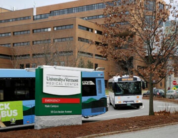 Buses travel through the main campus of the University of Vermont Medical Center, Friday Nov. 20, 2020, in Burlington, Vt.