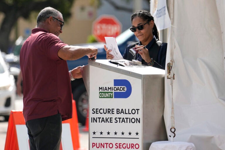 Employees process vote-by-mail ballots for the midterm election at the Miami-Dade County Elections Department, Tuesday, Nov. 8, 2022, in Miami. (AP Photo/Lynne Sladky, File)