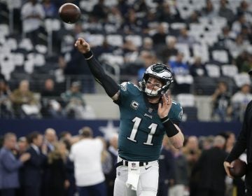 Philadelphia Eagles quarterback Carson Wentz (11) throws a pass throws a pass during warm ups before an NFL football game against the Dallas Cowboys in Arlington, Texas, Sunday, Dec. 9, 2018. (AP Photo/Michael Ainsworth)