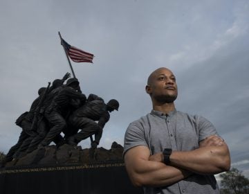 Reserve Marine Maj. Tyrone Collier stands with his arms crossed in front of the U.S. Marine Corps War Memorial