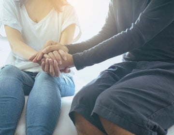 Man giving hand to depressed woman