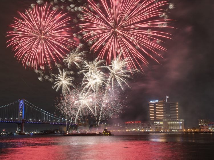 Fireworks are launched from a barge in the Delaware River as seen from Penns Landing.(Jonathan Wilson for WHYY)
