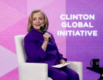 Hillary Clinton sits and speaks
