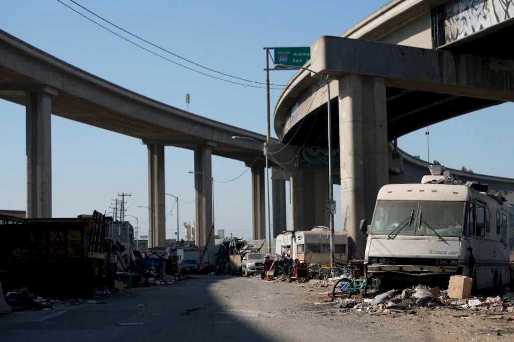Homeless encampment under a highway overpass