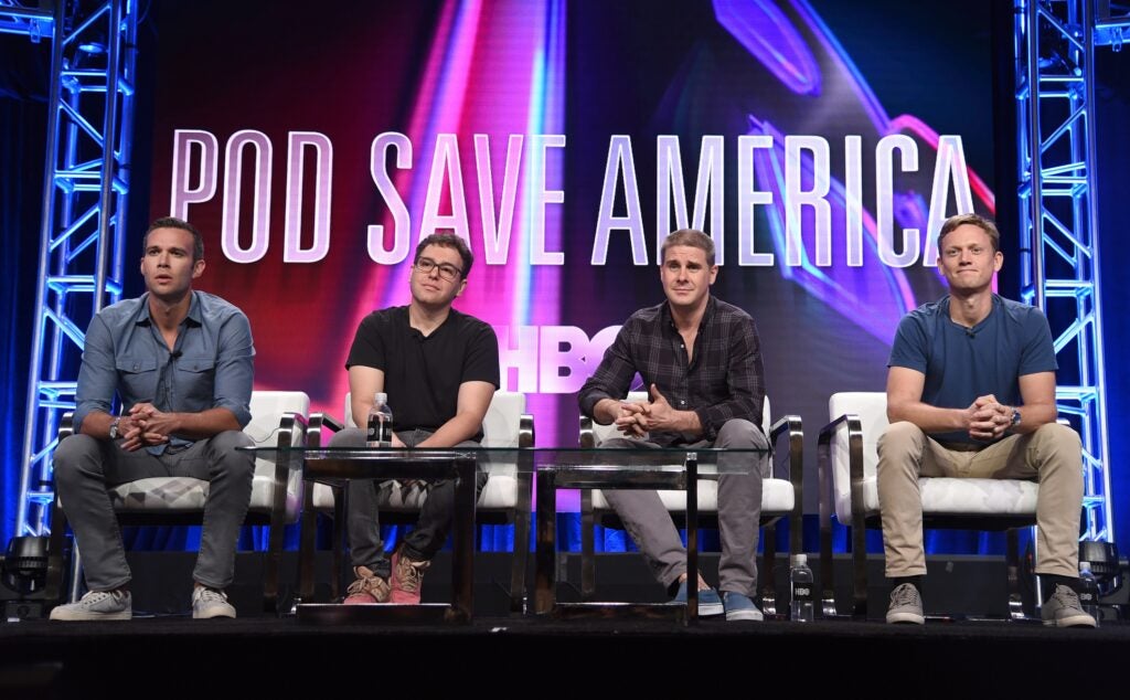 Pod Save America hosts onstage