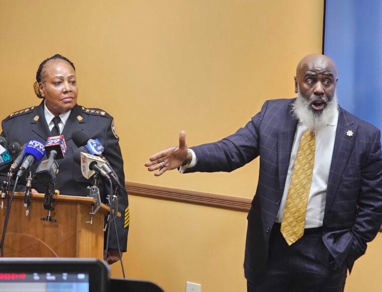 Sheriff Rochelle Bilal watches as First Deputy Tariq El-Shabazz speaks at a press conference.