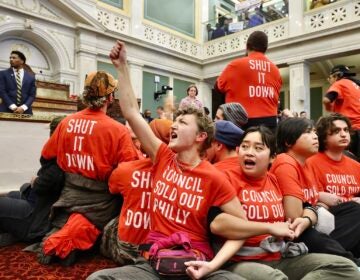 Protesters sitting on the floor and locking arms