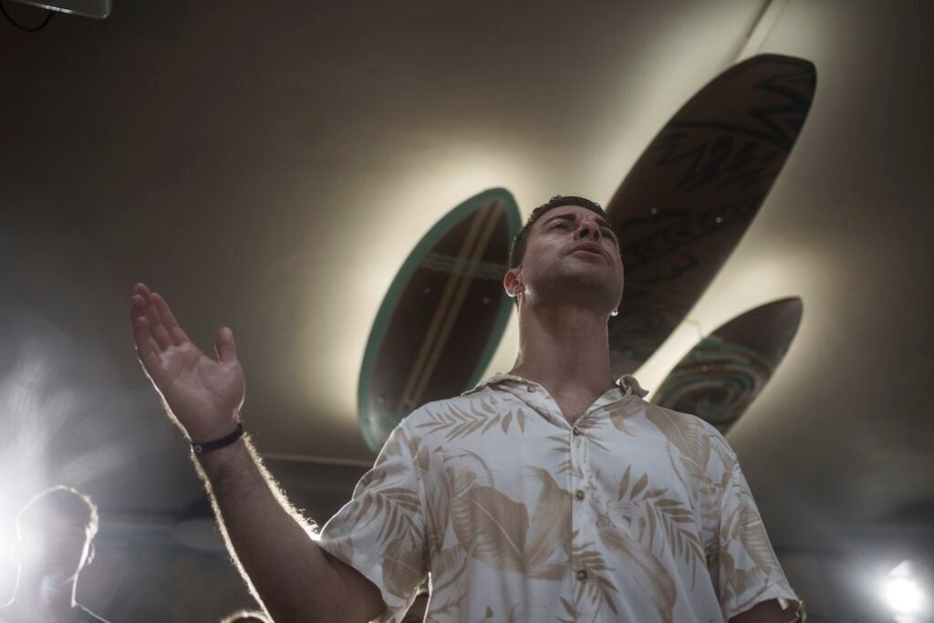 Surf Church pastor, Rev. Samuel Cianelli, preaches to his congregation at the church in Porto