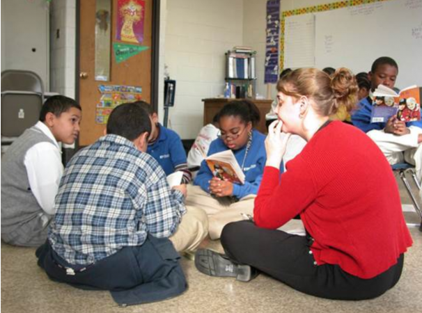Susan Larson planned to leave after a few years at KIPP, but stayed because of bonds formed with students. Here she reads with a group of students in the school's early years. (Photo provided by KIPP Philadelphia Schools)